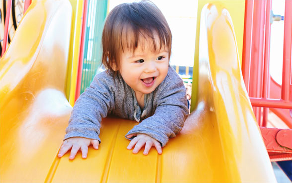 toddler on the slide, preschooler